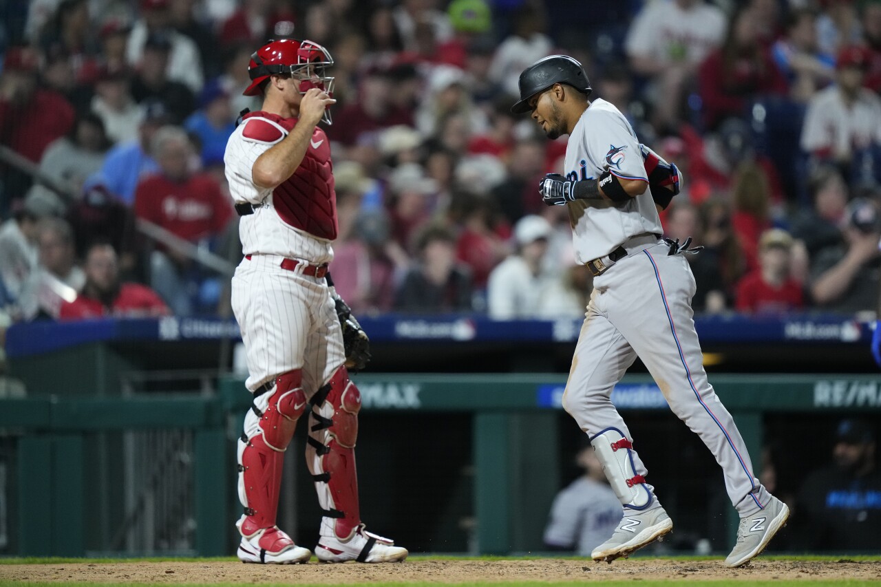 Miami Marlins slugger Luis Arraez scores past Philadelphia Phillies catcher J.T. Realmuto, April 11, 2023