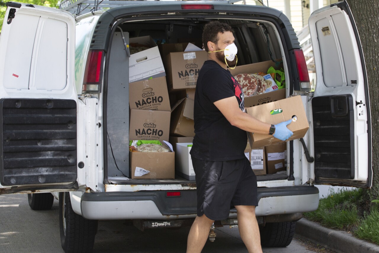 Volunteer unloads boxes from cargo van. Photo credit: Dan Herda, United Way