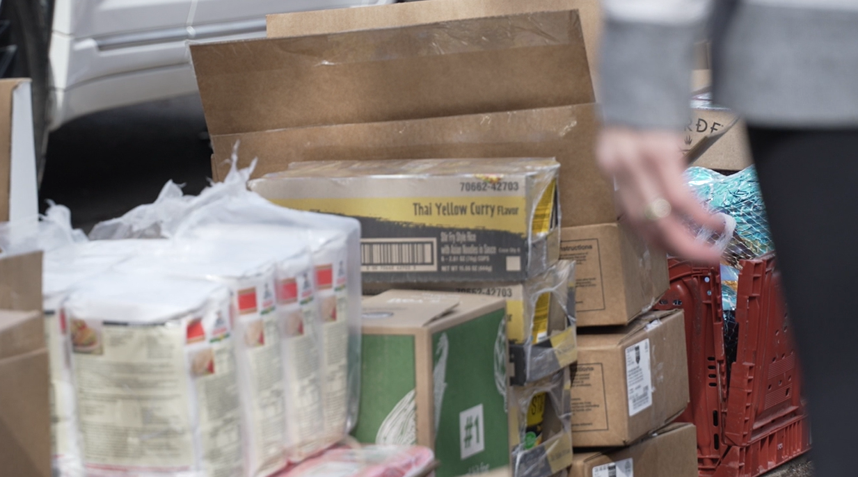 Volunteers distribute goods at apartment complex impacted by immigration raids.png