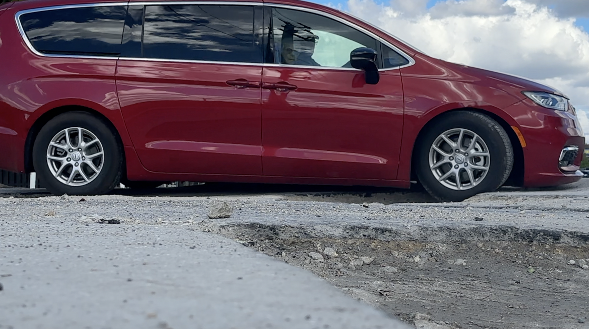 Van driving through potholes