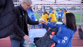 BYU fans give back to Cincinnati with coat drive before Bearcats showdown