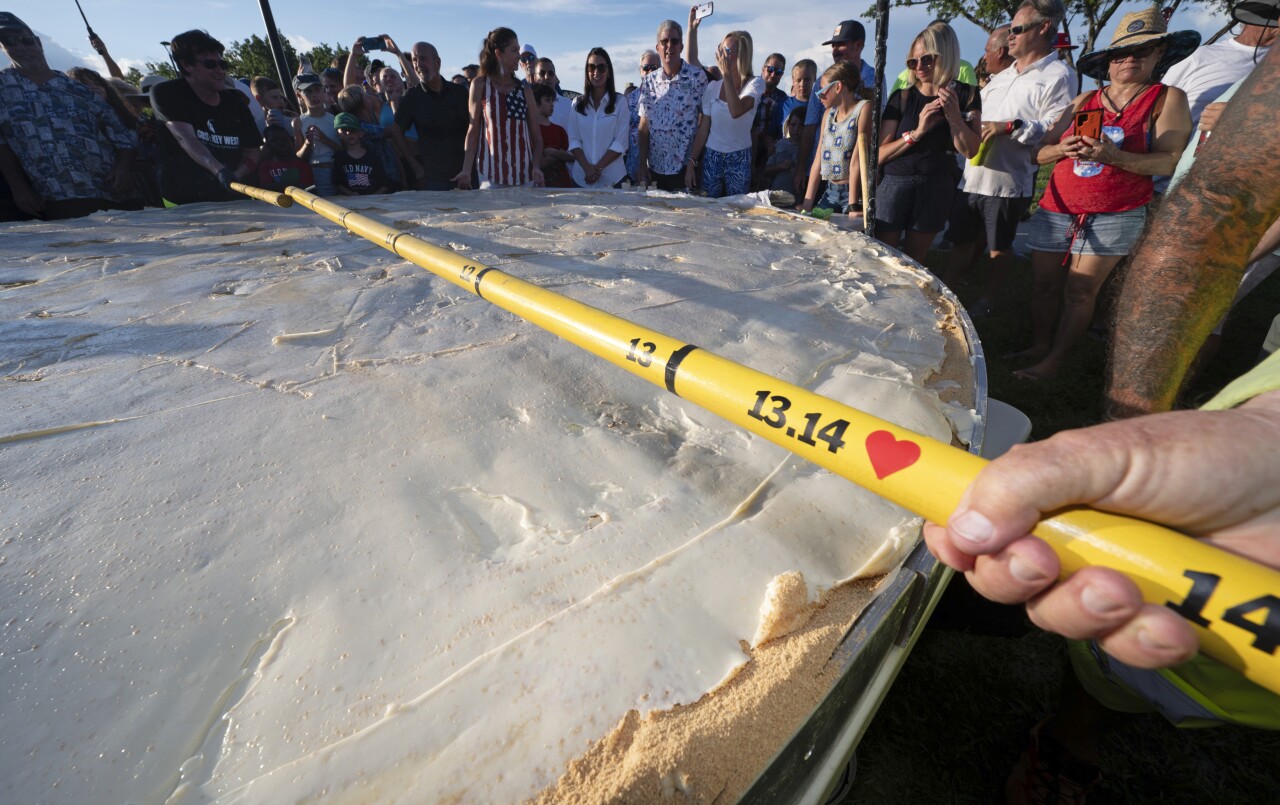 measuring tape confirms length of giant Key lime pie, July 3, 2023