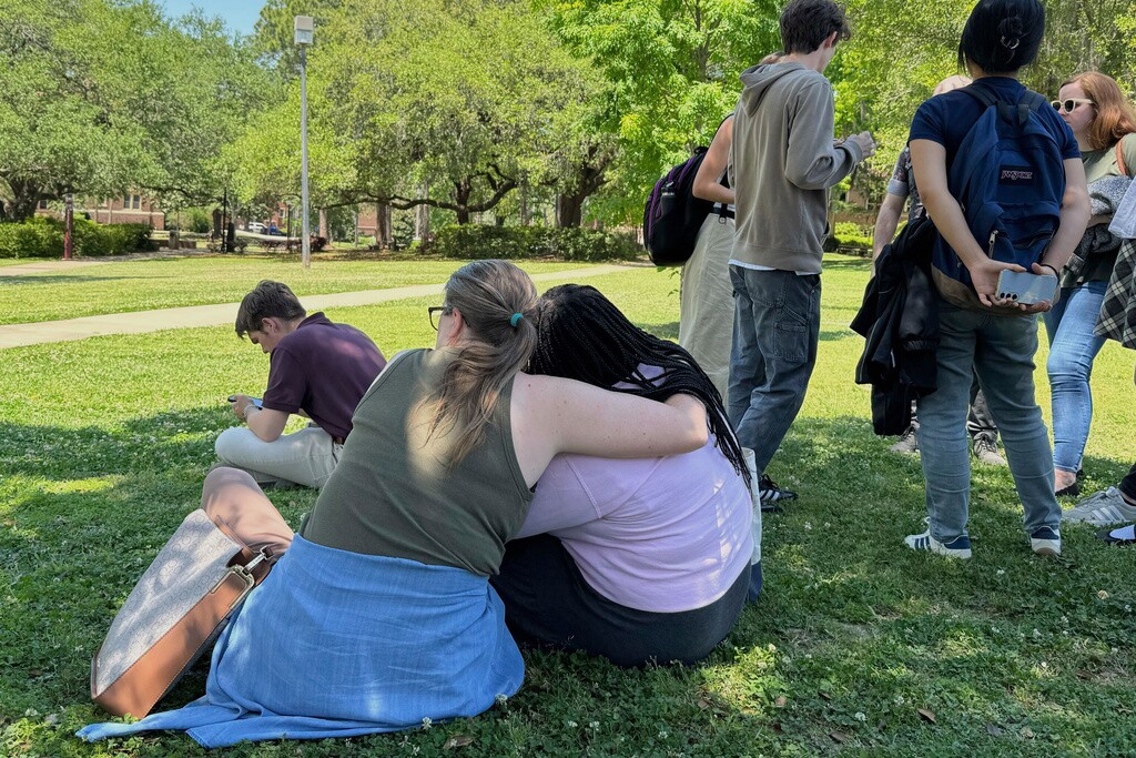 People comfort each other on Florida State University’s campus in Tallahassee, where law enforcement responded to a reported active shooter incident.