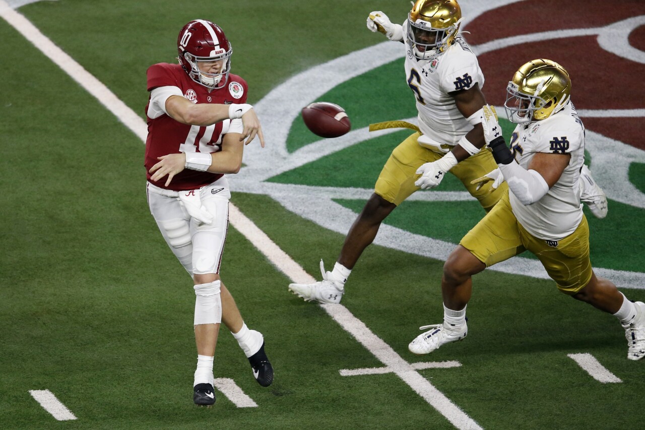 Alabama Crimson Tide QB Mac Jones throws under pressure from Notre Dame Fighting Irish in College Football Playoff semifinal at Rose Bowl