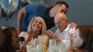Tyler Terens kisses his grandfather Harold Terens