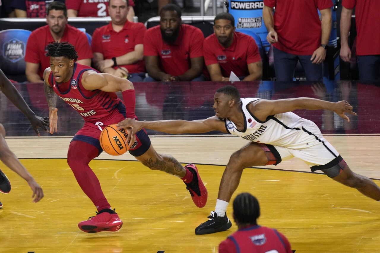 Florida Atlantic Owls guard Alijah Martin drives past San Diego State Aztecs guard Lamont Butler in second half of Final Four, April 1, 2023
