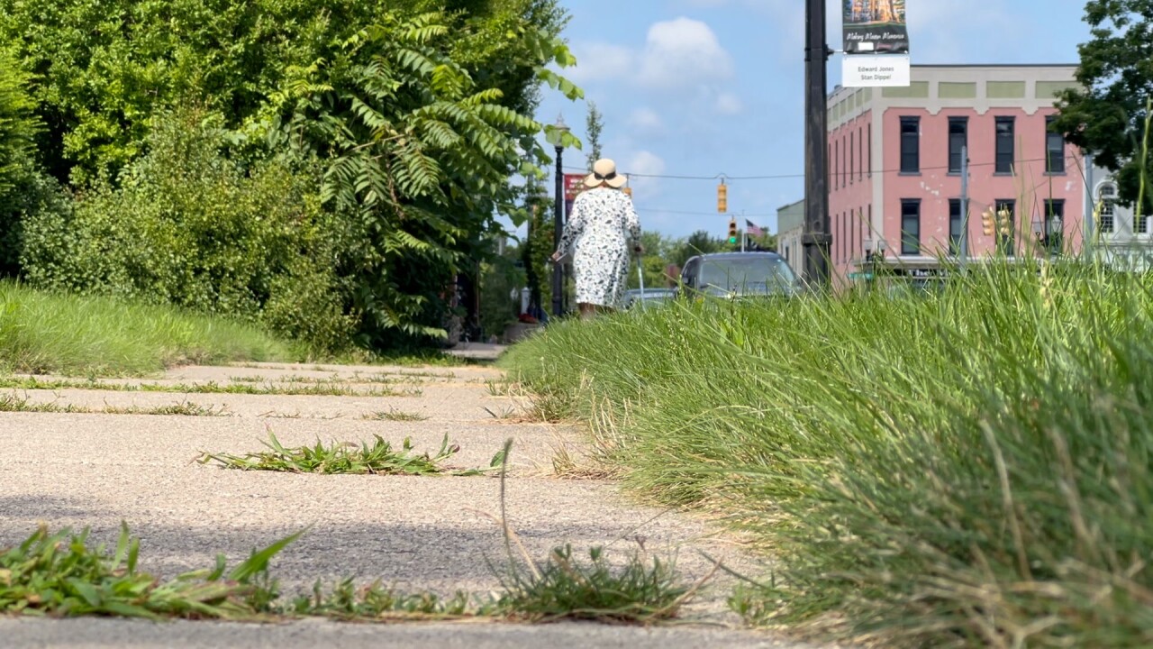 Joyce Lincoln, of Mason, walks to put letters in a mailbox