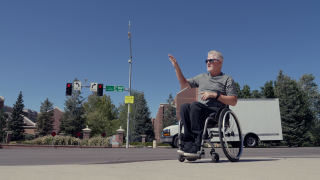 Scott Douglas explains the challenge of crossing a busy intersection as a wheelchair user. 
