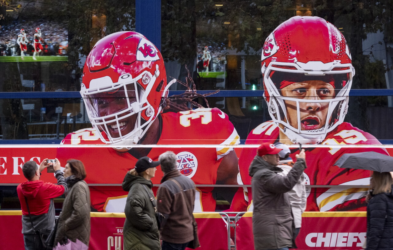 People walk past giant picture of Kansas City Chiefs QB Patrick Mahomes in Frankfurt, Germany, Nov. 4, 2023