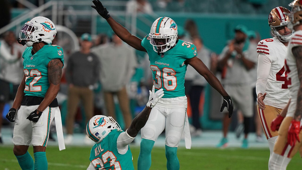 Miami Dolphins cornerbacks Storm Duck (36) and Siran Neal (33) celebrate after San Francisco 49ers place kicker Jake Moody (4) missed a field goal during the second half of an NFL football game, Sunday, Dec. 22, 2024, in Miami Gardens, Fla.