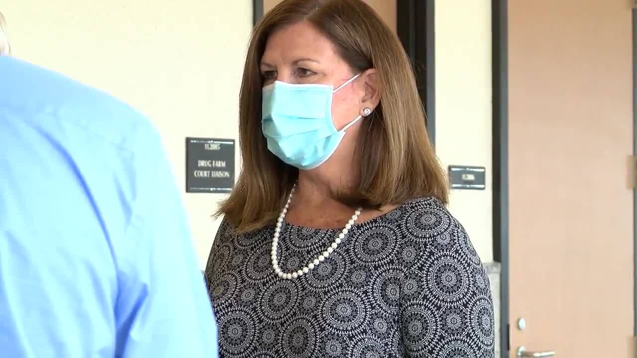 Susan Haynie listens as her attorney speaks after her plea deal, April 1, 2021