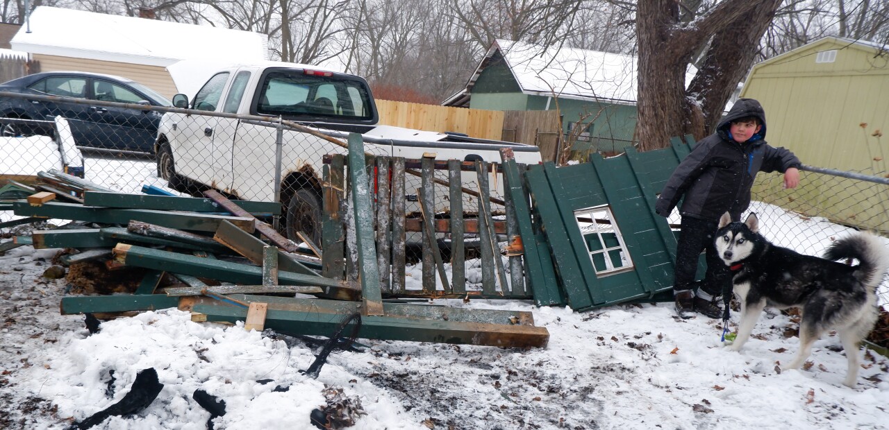 Virginia LaForce_s grandson with the family dog, Caesar. The playhouse beside them was torn down as LaForce and her husband prepared to leave their home. (Noor Hindi_The Devil Strip).jpeg