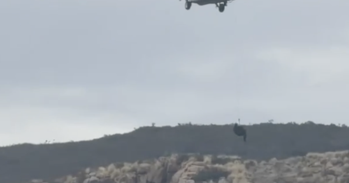 Flight medic dangles from helicopter rope in dramatic rescue