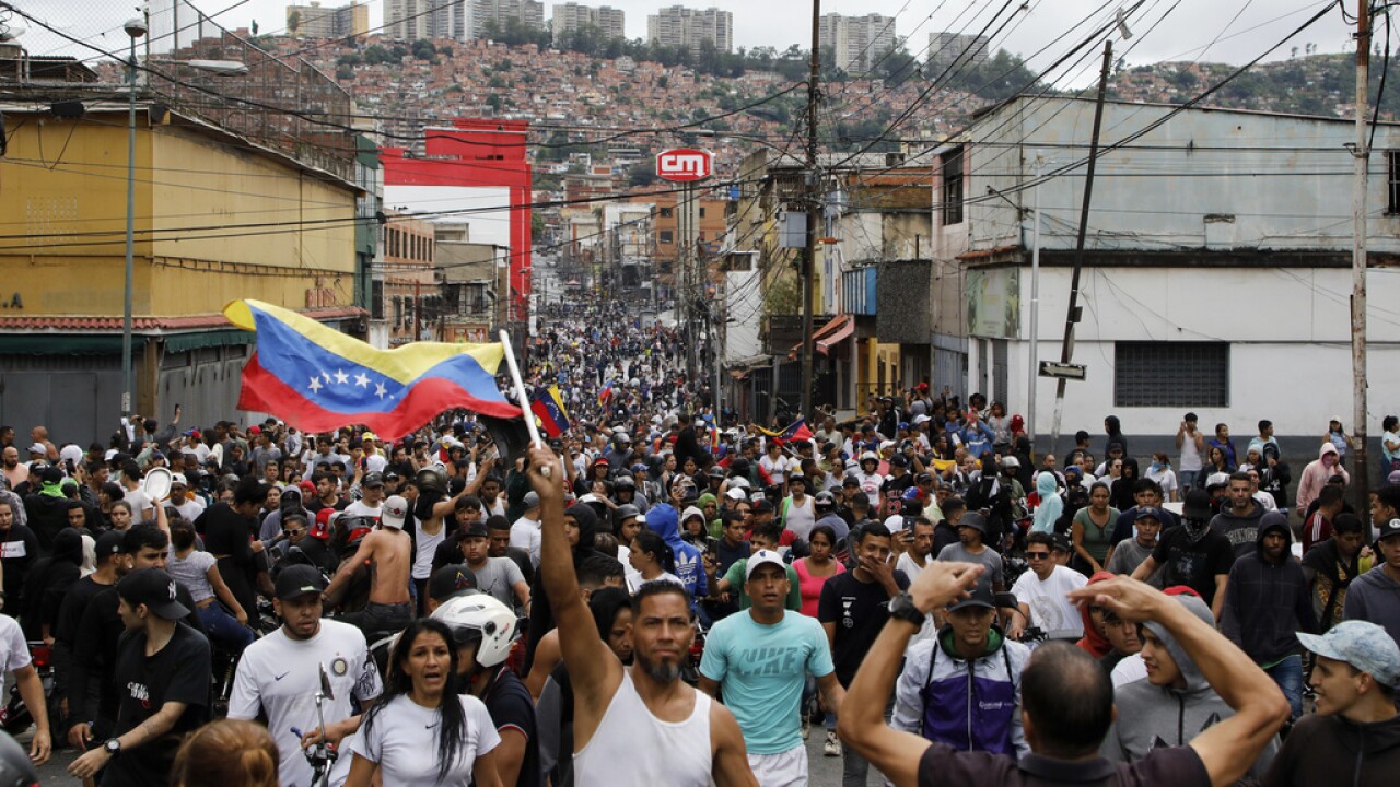 Protesters demonstrate against the official election results declaring President Nicolas Maduro won reelection in the Catia neighborhood of Caracas, Venezuela