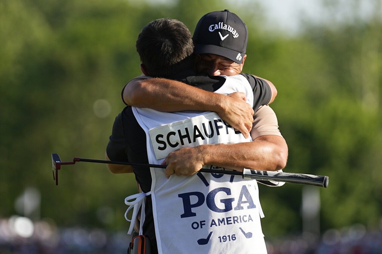 Xander Schauffele hugs his caddie Austin Kaiser after winning 2024 PGA Championship