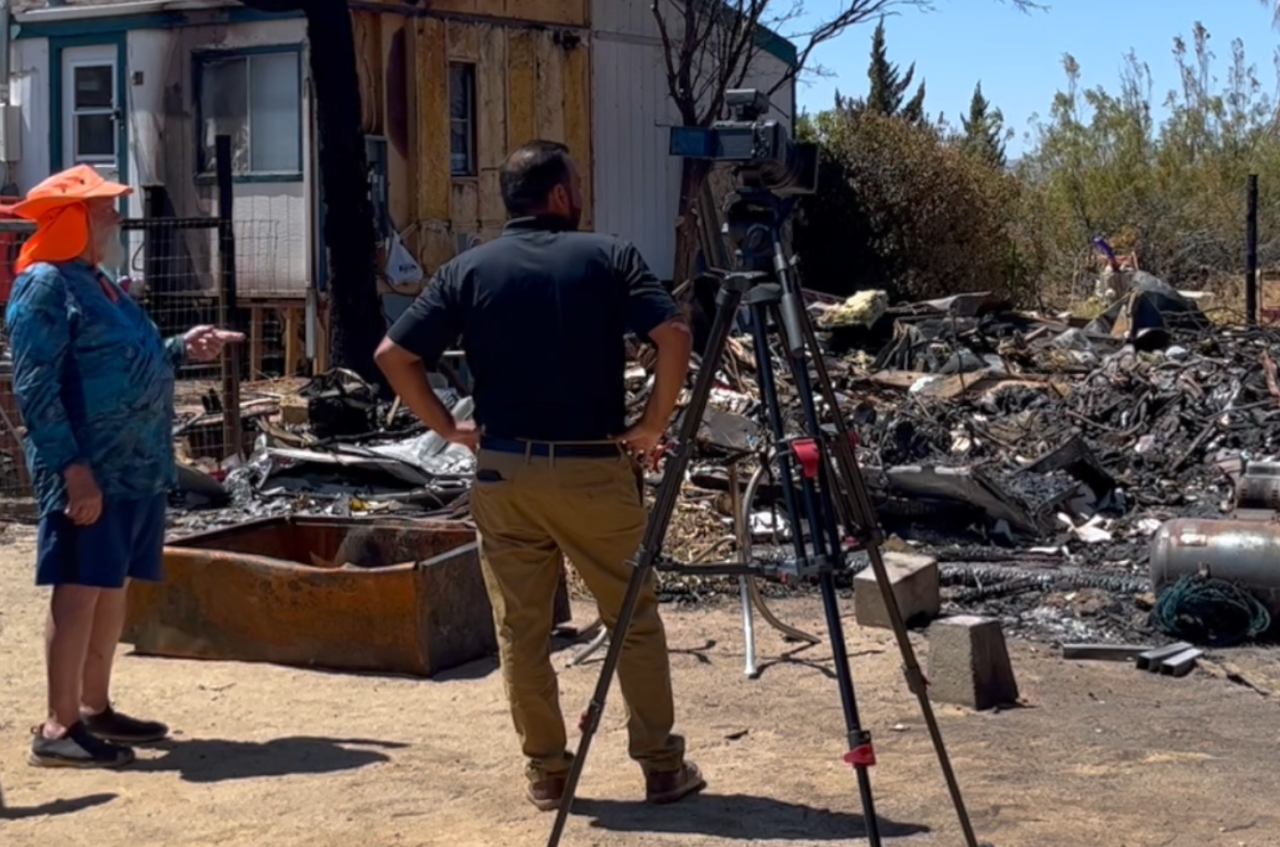 Neighborhood Reporter Steve Virgen surveying the damage at Rex Welker's home in Mojave