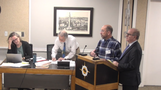 Tim Conder (in plaid shirt) speaks at a city board meeting about the restaurant
