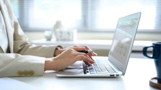 Stock image of an employee working on a computer.