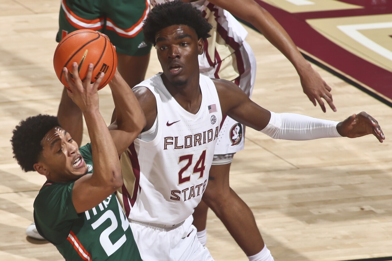 Miami Hurricanes guard Nijel Pack gets rebound as Florida State Seminoles center Naheem McLeod looks on, Jan. 24, 2023