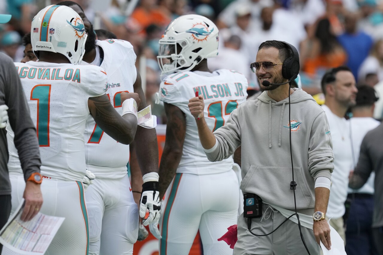 Miami Dolphins head coach Mike McDaniel fist bumps QB Tua Tagovailoa during second half vs. Denver Broncos, Sept. 24, 2023
