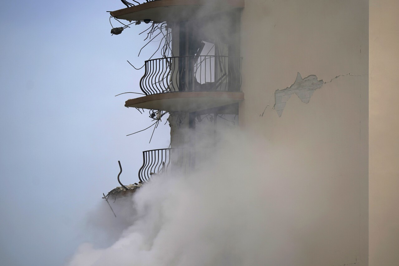 smoke rises from rubble of Champlain Towers South condo building, June 25, 2021
