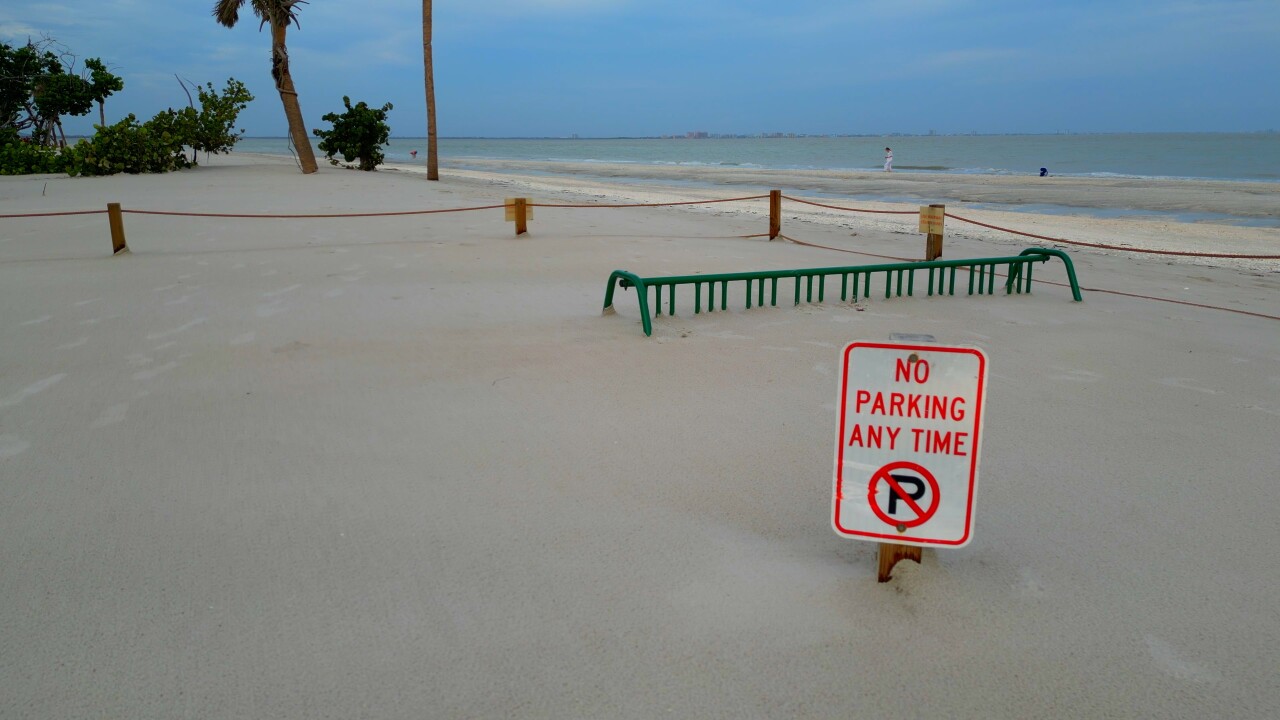 Sanibel Lighthouse Beach Park, bicycle rack submerged under sand.