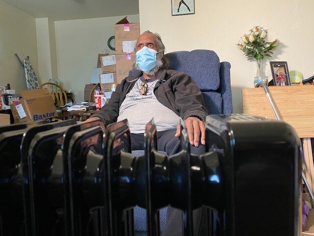 Walter Marshall in front of space heater