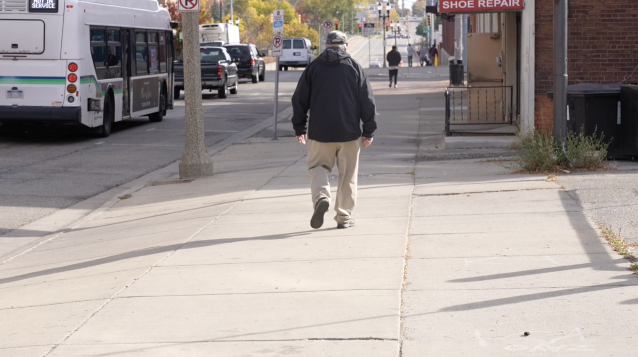 Pat Olsen walking to a bus