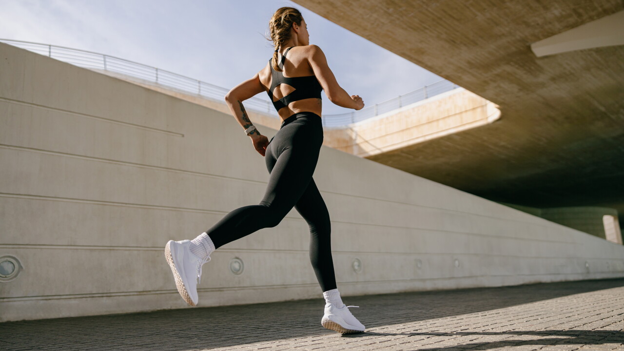 Back,View,Of,Woman,Athlete,In,Sportswear,Is,Running,On