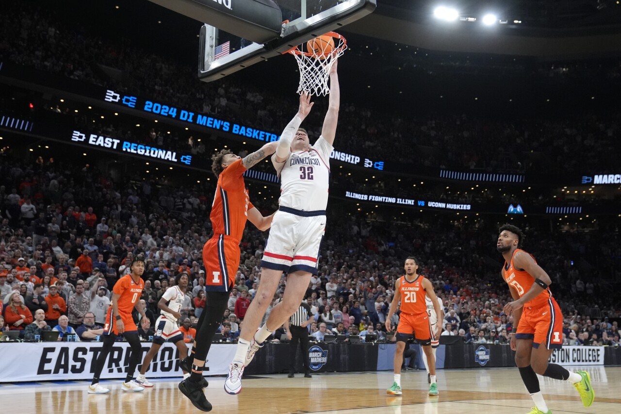 UConn Huskies center Donovan Clingan scores as Illinois Fighting Illini forward Coleman Hawkins defends during first half of Elite Eight, March 30, 2024