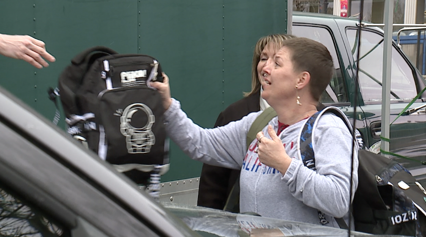 Amber Sanford collects her children's belongings they left at the parade.