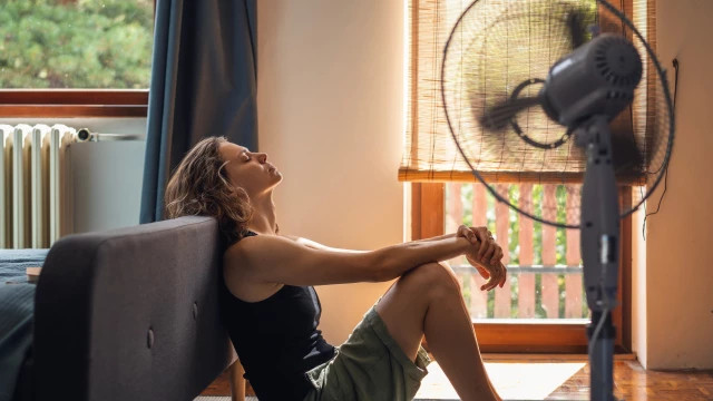 Woman suffering from extreme heat in her home.