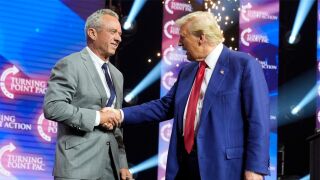 Republican presidential nominee former President Donald Trump greets Robert F. Kennedy Jr., at a Turning Point Action campaign rally, Oct. 23, 2024, in Duluth, Ga. 