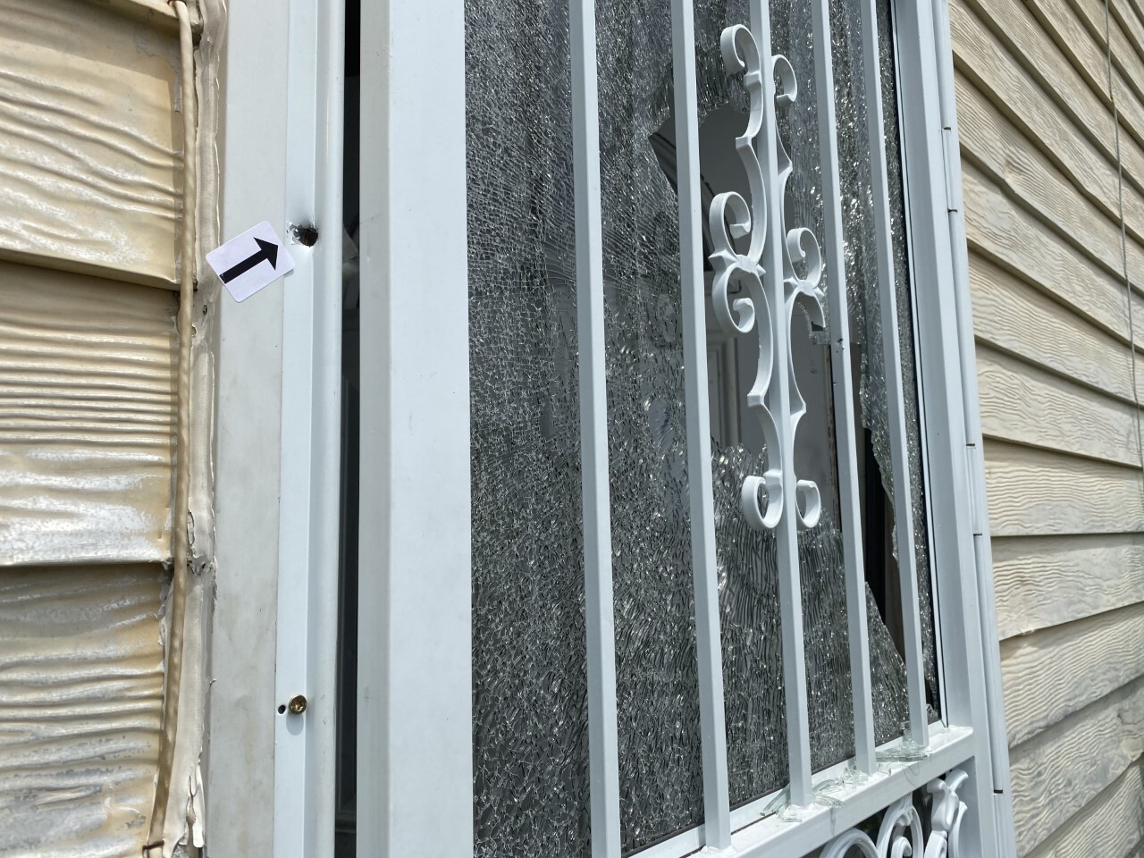 Bullet holes and shattered glass door.jpeg