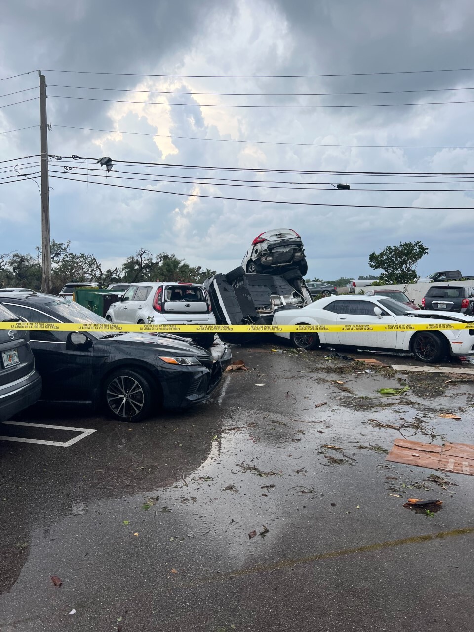 Yellow caution tape around cars on top of each other in Palm Beach Gardens, April 29, 2023