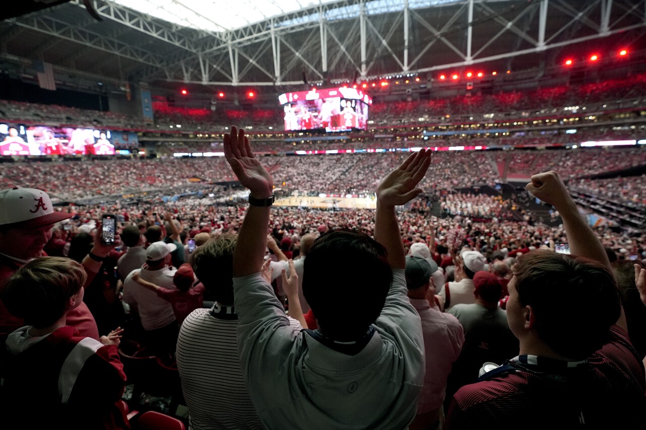 Fans cheer prior to the NCAA college basketball game between UConn and Alabama.