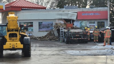 Semi driver crashes through Shell gas station