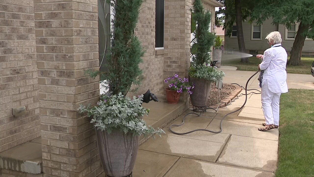 Agnes Gallo waters the plants outside her house in Parma.