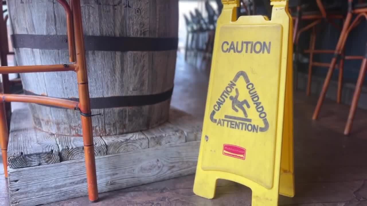 Caution sign on wet deck at Two Georges Waterfront Grille in Boynton Beach, Nov. 15, 2023