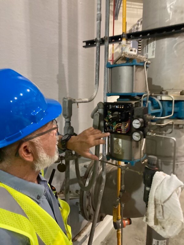 Anne Arundel County's Vincent-Dang Nguyen works on the membrane back post level control device and the membrane drain system in Jackson, Miss.