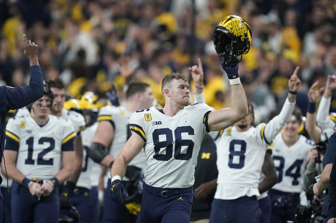 Michigan Wolverines tight end Luke Schoonmaker celebrates with teammates after winning 2021 Big Ten Conference Championship game