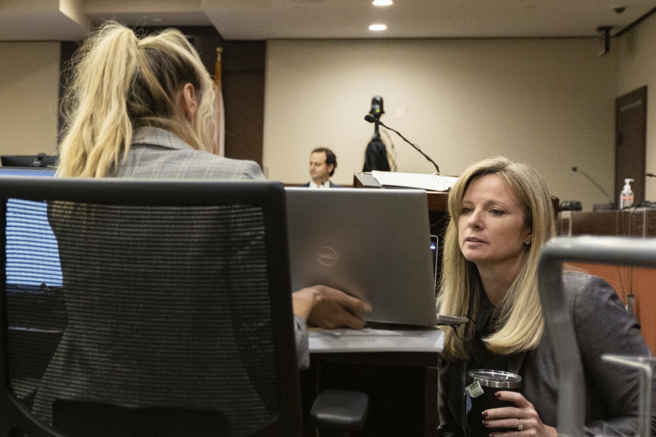 Prosecutors Georgia Cappleman and Sarah Dugan confer with each other during cross-examination of Charlie Adelson, Nov. 3, 2023