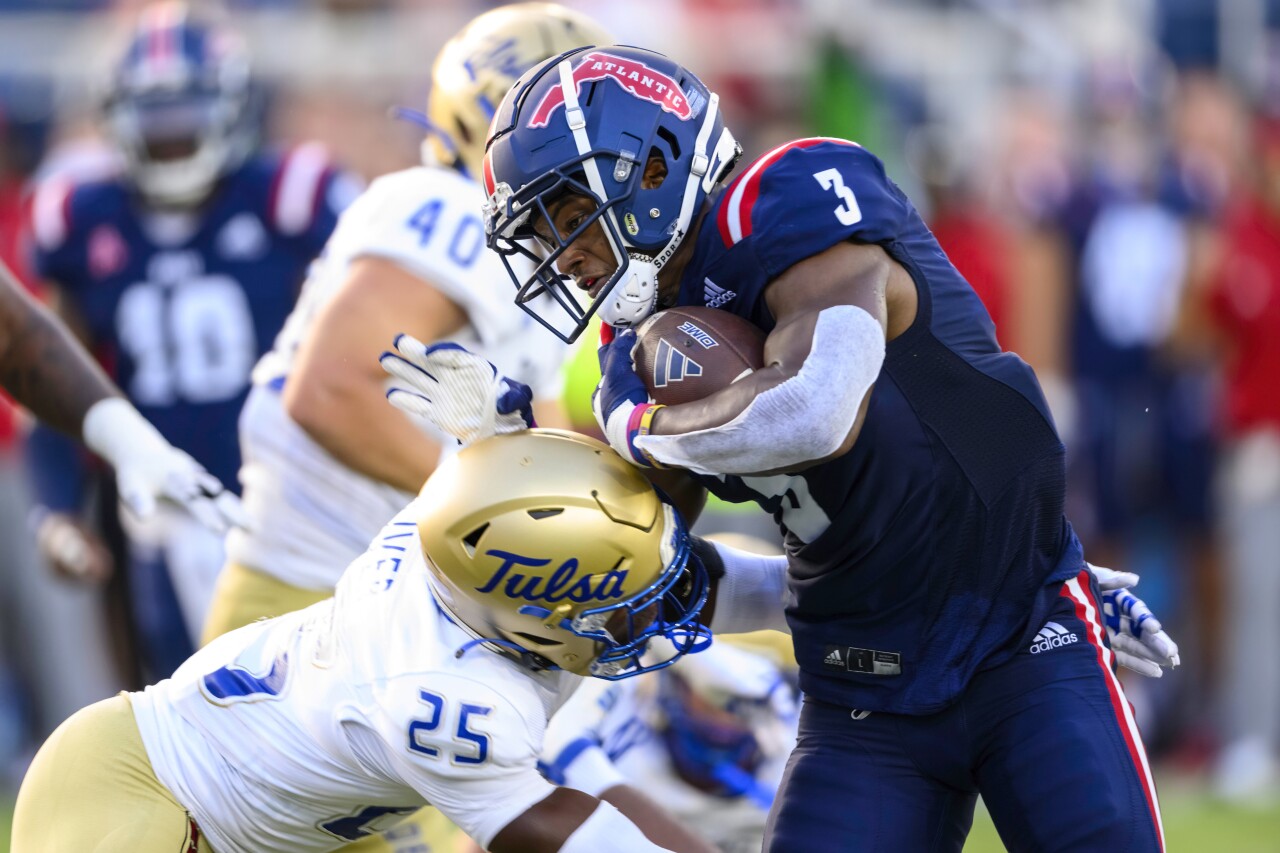 FAU Owls running back Larry McCammon tackled by Tulsa Golden Hurricane safety Jaise Oliver, Oct. 7, 2023