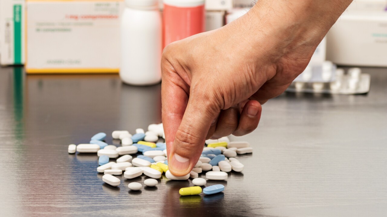 Cropped,Shot,Of,A,Man,Hand,Catching,A,Pill,From