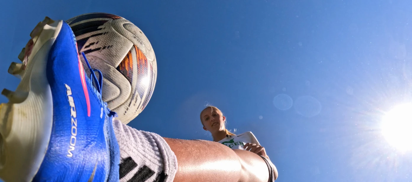 Cora kicking soccer ball
