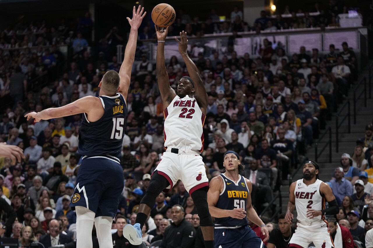Miami Heat forward Jimmy Butler shoots over Denver Nuggets center Nikola Jokic during first half of Game 2 of NBA Finals, June 4, 2023