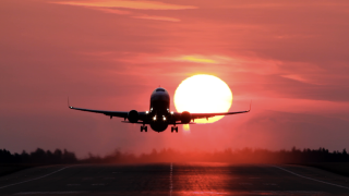 plane taking off sunset