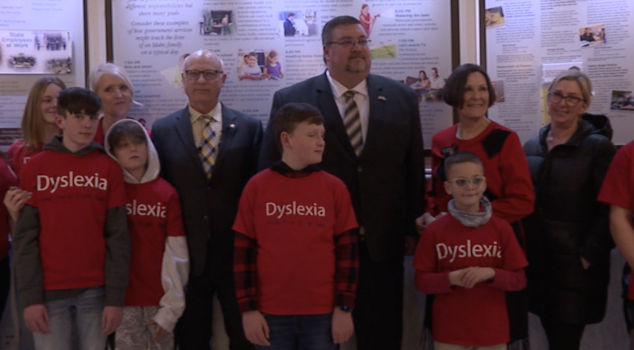 Lawmakers and families involved with Decoding Dyslexia Idaho stand for a photo following a news conference in February.