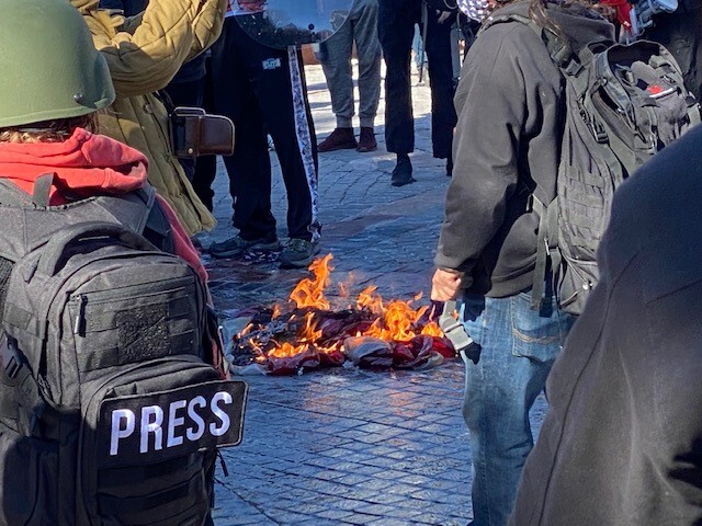 Protesters burn American flag