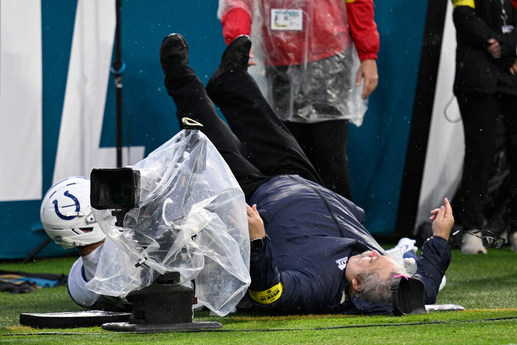 Indianapolis Colts wide receiver Michael Pittman Jr., left, falls into a security guard standing along the sideline on a pass play during the second half of an NFL football game against the Jacksonville Jaguars, Sunday, Dec. 7, 2025, in Jacksonville, Fla.